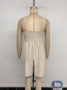 Detail of back smocking and adjustable straps on beige cotton linen summer jumpsuit