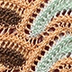 Detailed close-up of multi-color bohemian crochet fabric and intricate knit texture