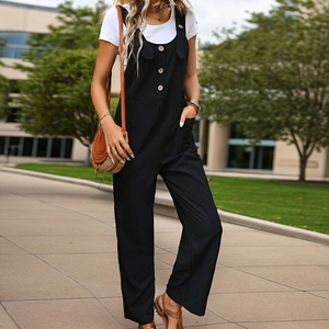 Women's minimalist black cotton linen overalls with wide leg design and wooden button detail