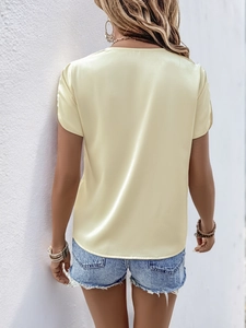 Back view of elegant light yellow satin blouse with round neck and silky finish