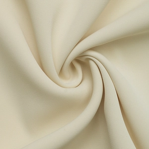 Detailed macro view showing the textured cream fabric and soft knit material of the summer blouse