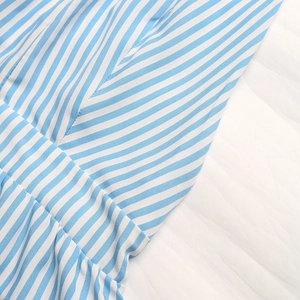 Close-up of blue and white striped fabric showing high-quality stitching and texture