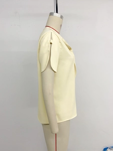 Detail view of cream short sleeve blouse showing tulip slit sleeve design on mannequin