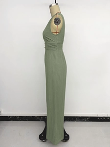 Detailed side view of grass green sleeveless jumpsuit with smocked waist and waffle texture