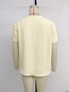 Back view of a pale yellow round-neck short-sleeve shirt in smooth woven fabric