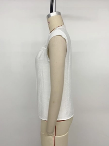 Detail view of white lace hollow-out stitching and breathable fabric on summer sleeveless top