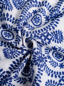 Gros plan du tissu imprimé floral bleu et blanc sur la robe d'été fendue