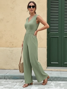Detail of sage green sleeveless jumpsuit with smocked waist and V-neck in cotton-linen