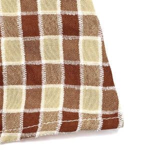 Detail of brown and beige checkered fabric with precise white single-needle stitching