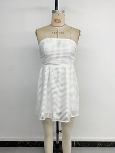 Detail of white mesh fabric texture and strapless high waist design on a mini dress