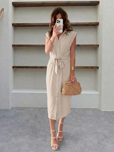 Détail d'une robe chemise en lin beige avec manches volantées, lien à la taille et boutonnage