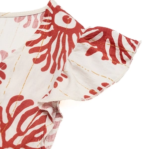 Détail de robe d'été à col en V avec imprimé floral rouille et fines rayures dorées