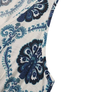 Close-up of bohemian paisley floral print on woven fabric with detailed stitching