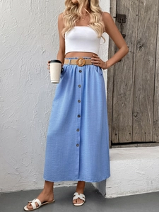 Detailed view of light blue A-line skirt with wooden buttons and a woven straw belt