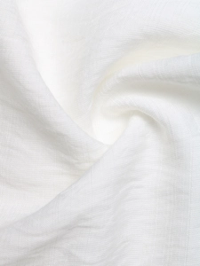Close-up of white breathable fabric texture with delicate lace hollow out embroidery