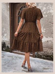 Detail view of the tiered bohemian leopard print midi dress with flutter sleeves and waist