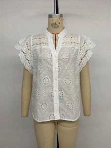 Detail of white cotton eyelet embroidery blouse with V-neck and ruffle sleeves
