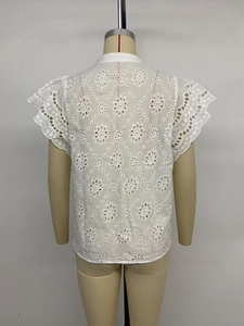 Detail of white short sleeve blouse featuring intricate floral eyelet embroidery on back