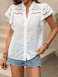 Detail of white hollow lace shirt featuring eyelet embroidery and ruffle sleeve cuffs