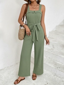 Detail of sage green wide-leg jumpsuit with drawstring waist and textured fabric finish