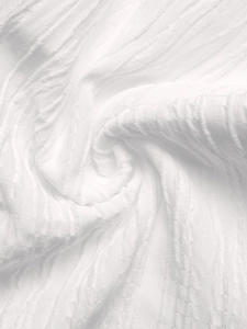 Detail shot of white seersucker fabric with vertical texture and breathable gauze weave
