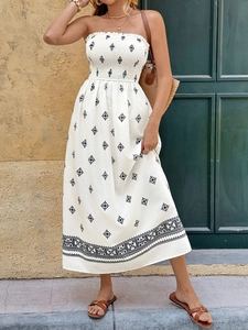 Detailed view of white strapless midi dress with black geometric prints and smocked bodice