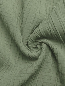Close-up of the green waffle knit texture fabric with high-quality soft weave details