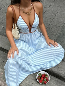 Detail of blue and white striped halter dress with brown trim and V-neckline