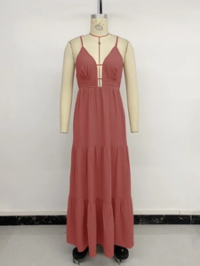Detail view of the deep V-neck and tiered skirt structure of this dusty pink maxi dress