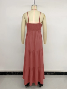 Detail view of pink maxi dress with adjustable straps and elastic smocked back design