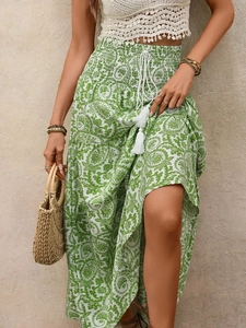 Detailed view of the paisley print skirt with elastic waist and white tassel drawstrings