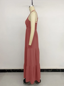 Detail of summer vacation dress featuring tiered skirt layers and elastic smocked back