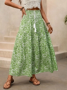 Detail of smocked elastic waist with white tasseled drawstring on paisley maxi skirt