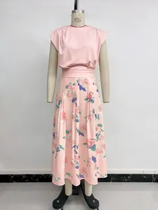 Détail d'un ensemble rose deux pièces avec crop top sans manches et jupe longue fleurie