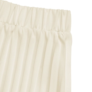 Detailed view of elastic waistband and pleated fabric texture on a cream skirt