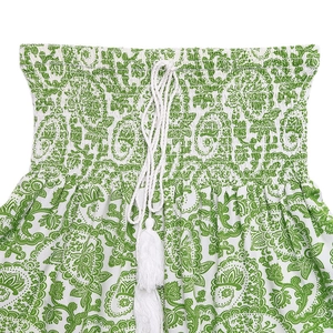 Detail of smocked elastic waist with white drawstring tassels and green paisley print