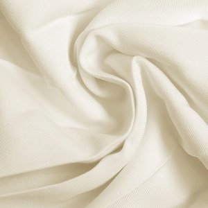 Detailed macro view showing the fine horizontal texture of the soft cream knitted fabric