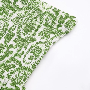 Detail of smocked elastic waistband on white paisley floral summer long skirt