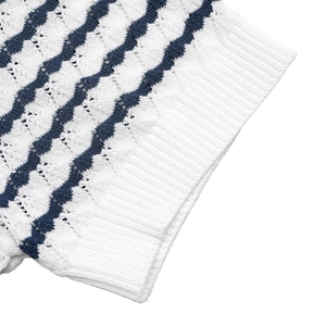 Close-up of a white knitted t-shirt with navy wavy stripes and intricate cutout details