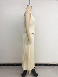 Detail view of cream sleeveless vest top and pleated maxi skirt set for office wear