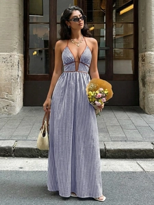 Detail of blue and white striped halter maxi dress featuring deep V-neck and waist detail