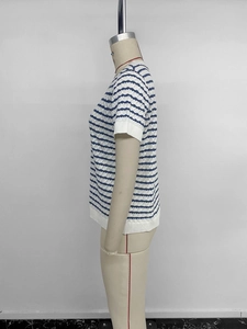 Detail of blue and white striped knit top with hollow wave crochet texture and ribbed hem