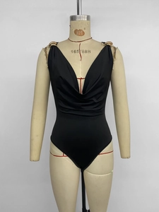 Detail view of black V-neck bodysuit with elegant gold ring buckles on the shoulders