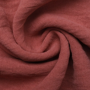 Detailed macro view of the rust-colored woven fabric texture with spiral pleats