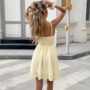 Sleeveless backless light yellow mini dress with smocked detail and ruffle hem for summer