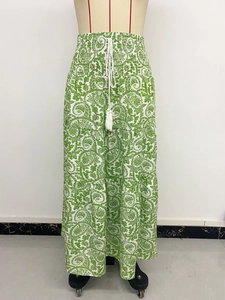 Detail of paisley print maxi skirt with elastic drawstring waist and tassel accents