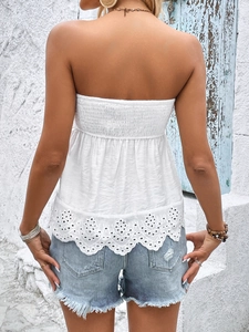 Detail of white smocked tube top with delicate eyelet lace trim and back elastic design
