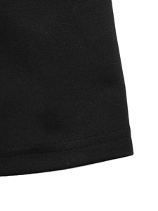 Close-up of double-needle stitching on the hem of a black knitted casual T-shirt dress