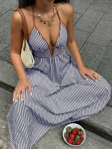 Detail of blue striped V-neck halter dress with brown piping and decorative necklace