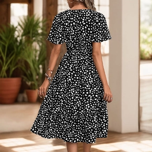 Women's black V-neck tiered midi dress with white polka dot print and short sleeves